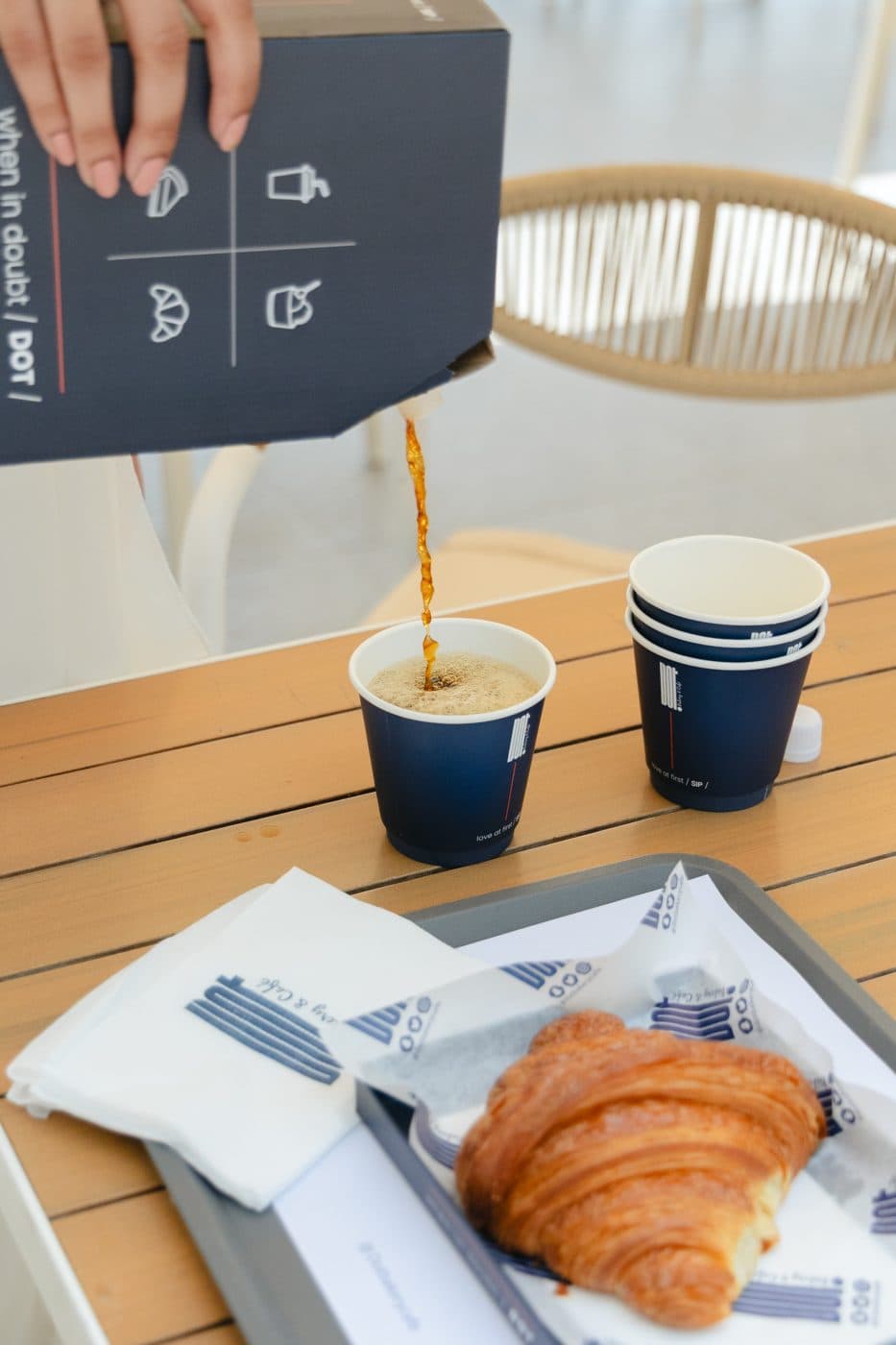 Pouring coffee into DOT cups