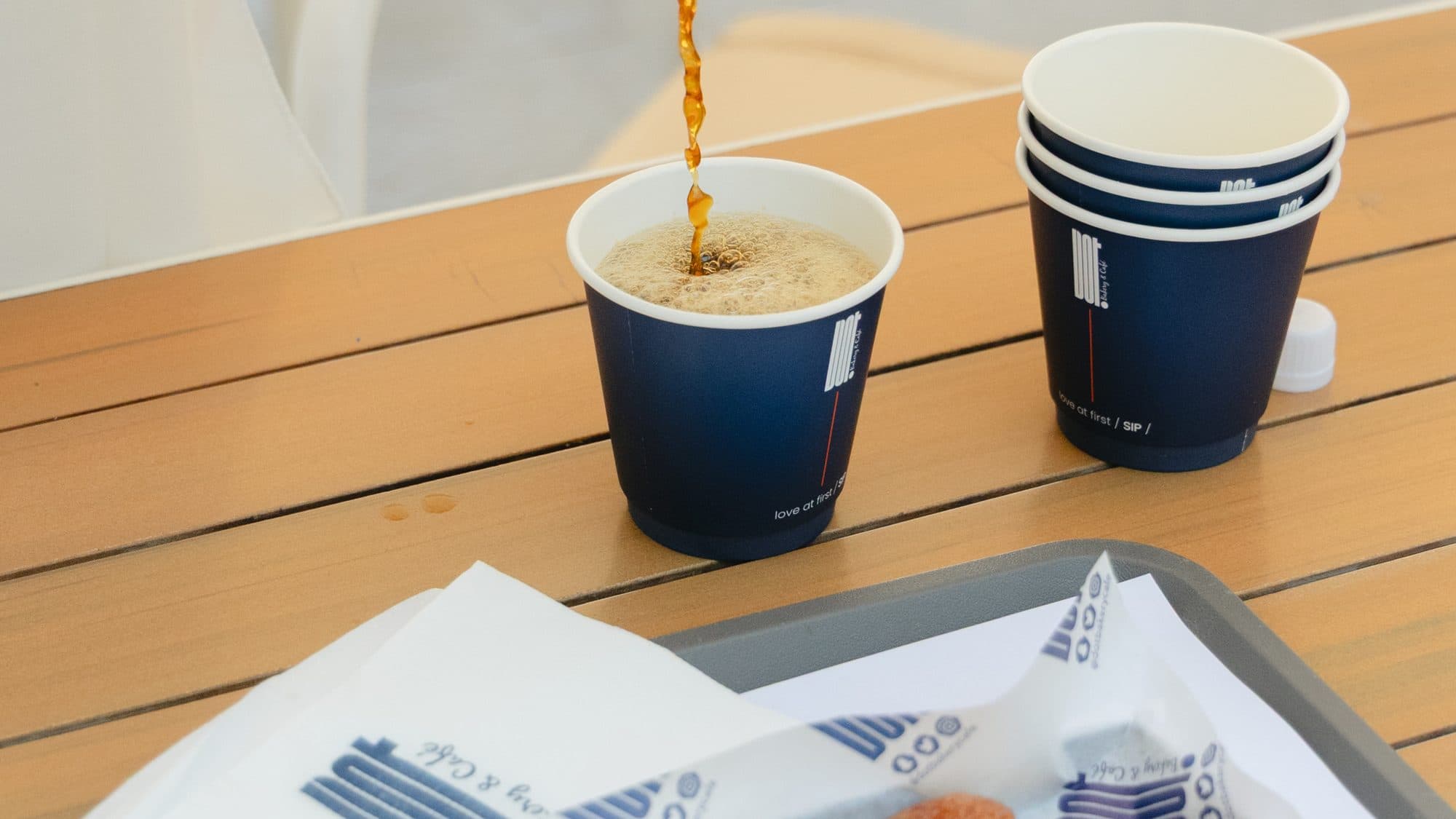 A table at DOT: coffee and a croissant