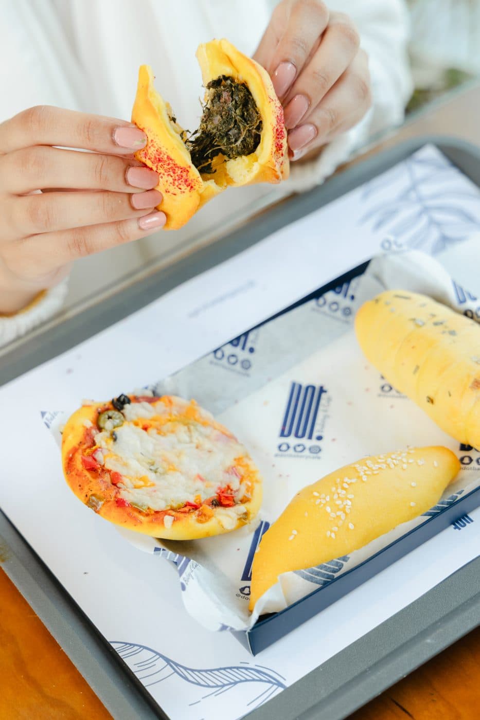 A DOT pastry held in two hands